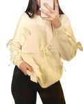 Sweter z kokardkami