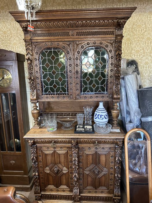 antyczny, rzeźbiony kredens dębowy z witrażowymi drzwiczkami.