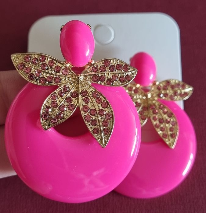 Brincos em acrílico, de pico, em rosa fucsia e apontamentos dourados.