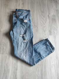 Niebieskie spodnie jeansy z dziurami Levi's 501