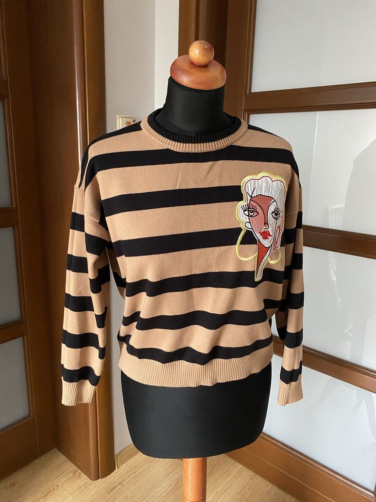 Damski gruby sweter w paski z naszywką