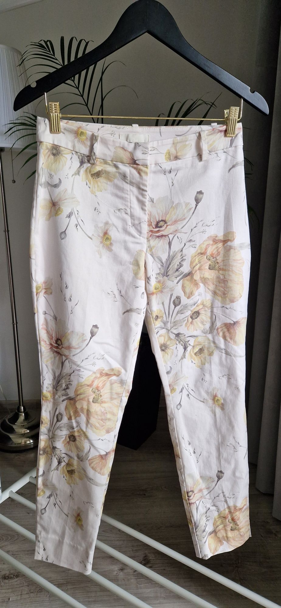 Białe spodnie damskie w kolorowe kwiaty H&M rozmiar M
