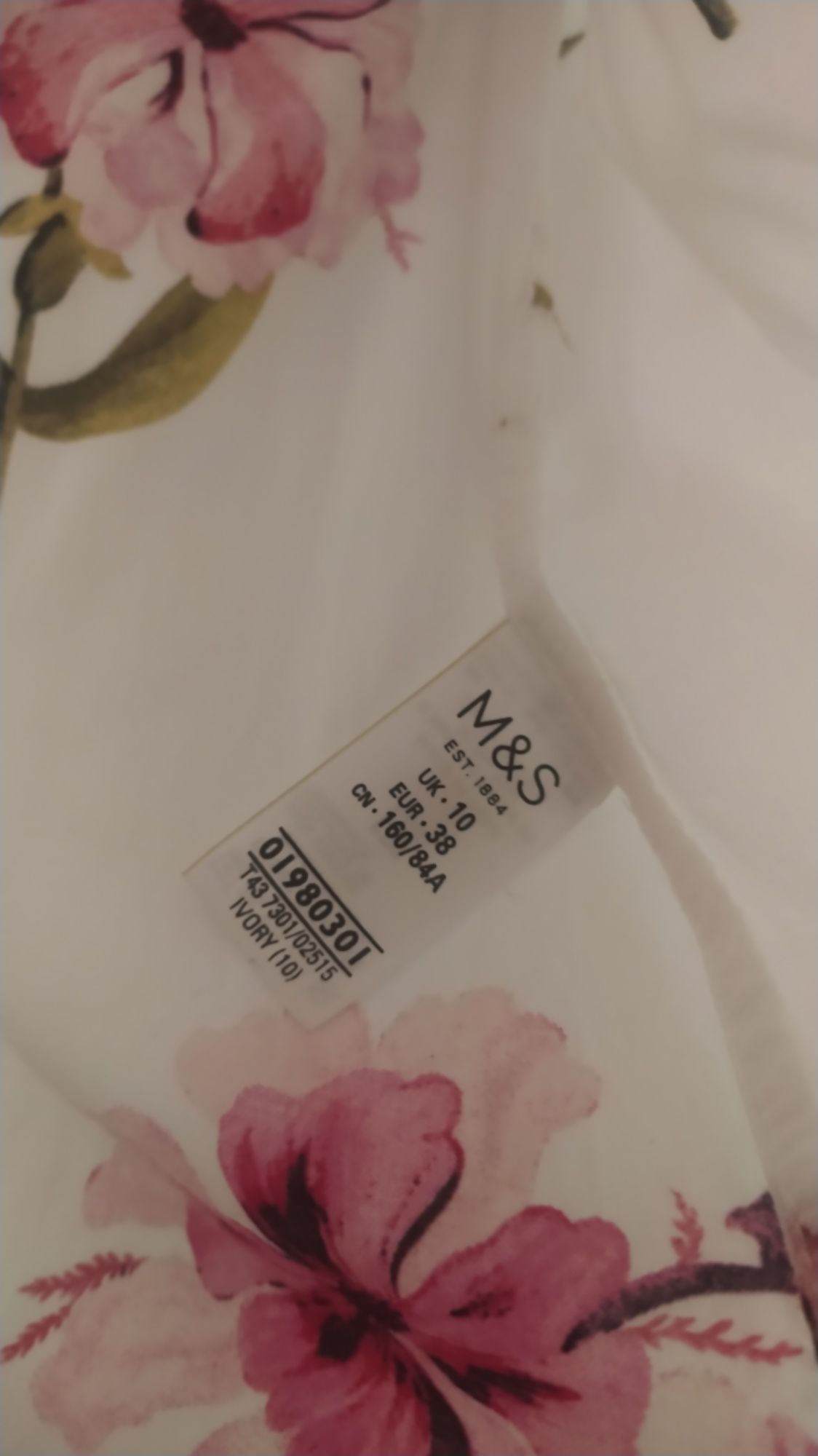 Biała bluzka w kwiaty z koronka i wiązaniem 38
