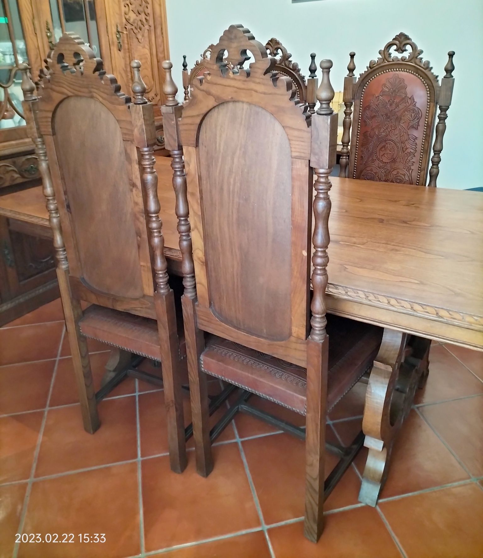 Mesa e cadeiras em madeira de nogueira maciça, forradas a couro.