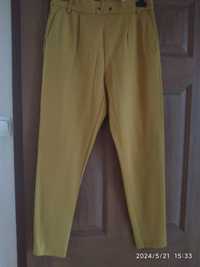 Spodnie damskie leginsy, kolor musztardowy, r M/L, używane