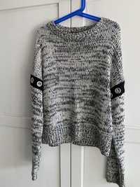 Sweter z modnym wzorem na rękawie