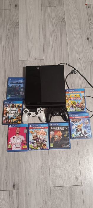 PS 4 pro z dwoma padami oraz gry na zdjęciu