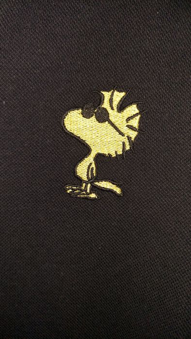 Pólo preto Peanuts 9-10 anos
Novo