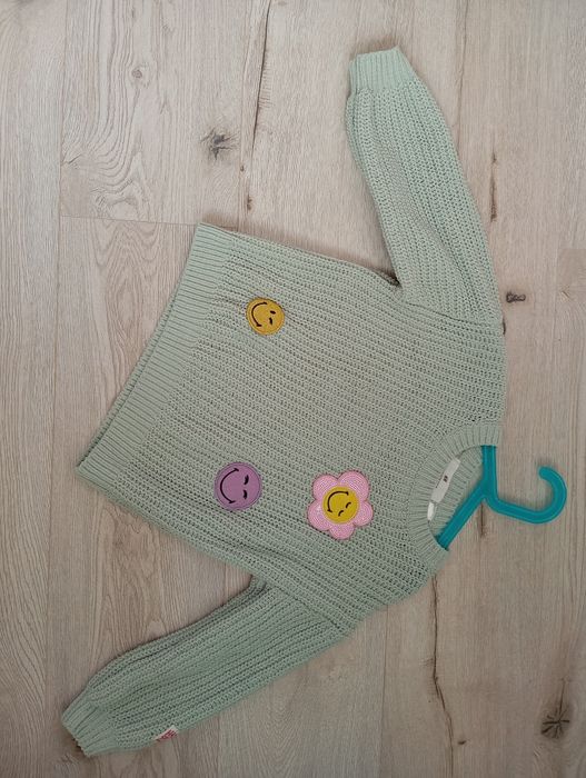 Ażurowy sweterek dla dziewczynki miętowy kolor z kolorowymi  naszywkam