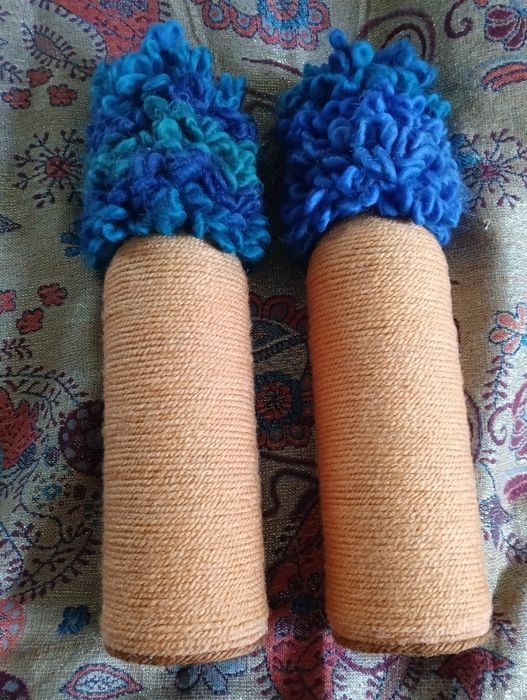 Ozdobne szklane butelki oplecione włóczką.