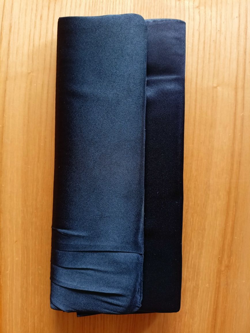 Czarna kopertówka z ozdobną bransoletą na nadgarstek