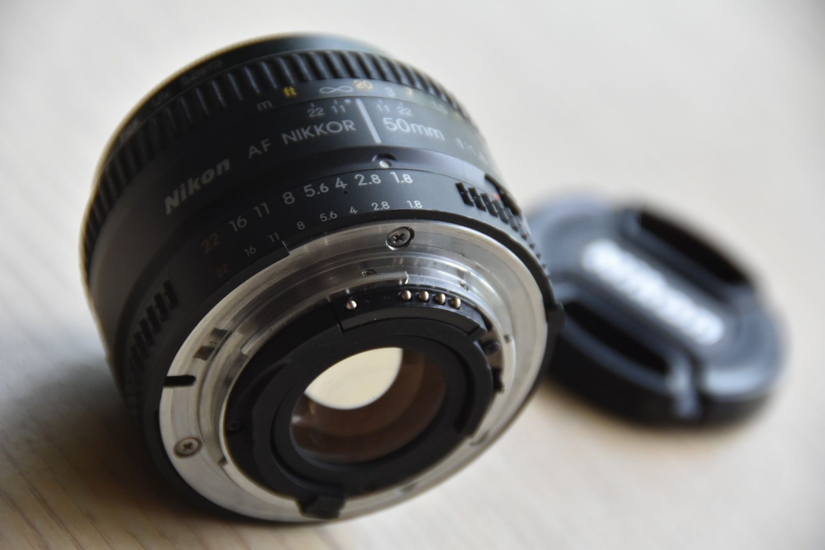 Nikkor 50 1.8 D AF + filtr UV + 2x dekielki + futerał Nikon obiektyw