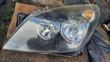 Opel Astra H 3 III lampa przednia przód lewa oryginał HELLA