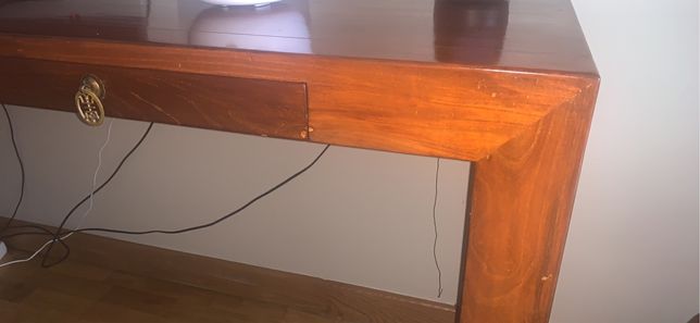 Mesa comprida em madeira maciça, a grossura da madeira e a quese ve na