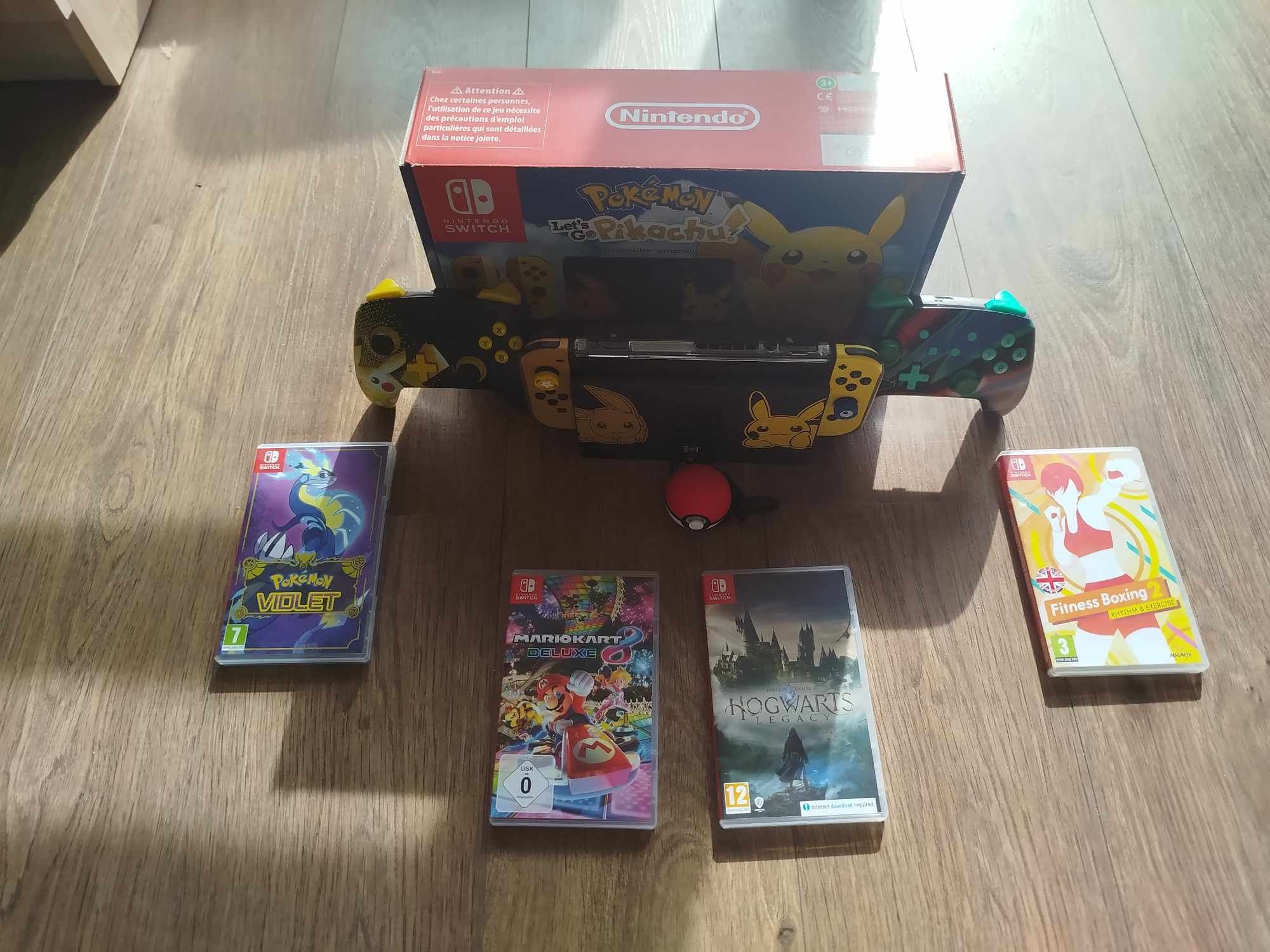 Nintendo Switch Let's Go Pikachu + 2 pady + 8 gier