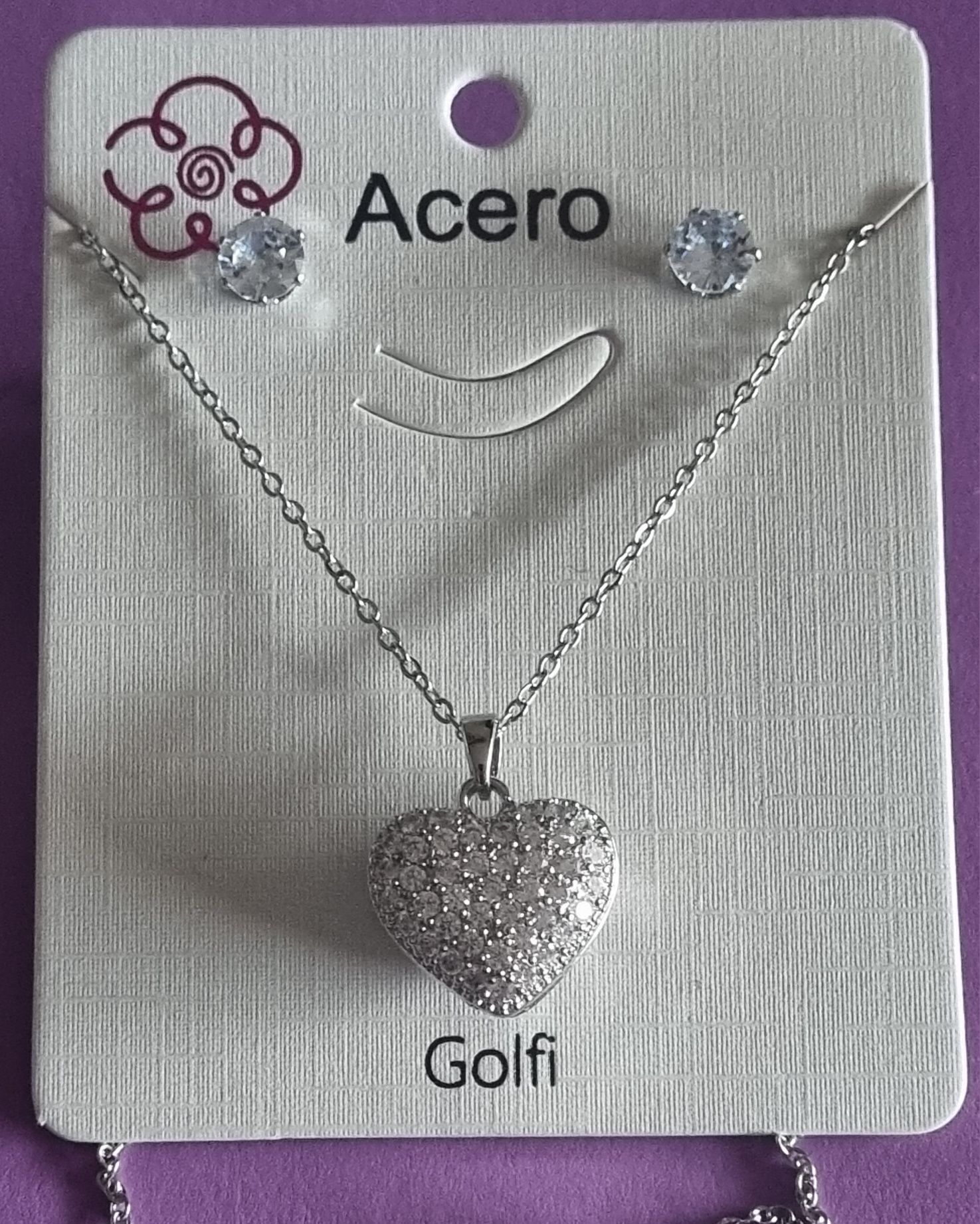 Conjunto prateado (colar e brincos), em aço, coração de zirconias.