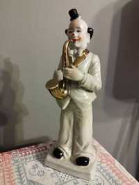 Klaun z saksofonem z porcelany wys.26 cm.