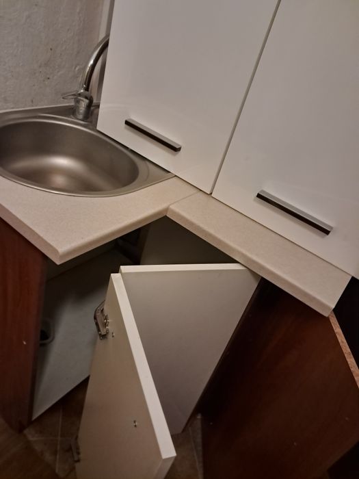 Narożnikowe meble w biały połysk zlew z baterią i szafkam