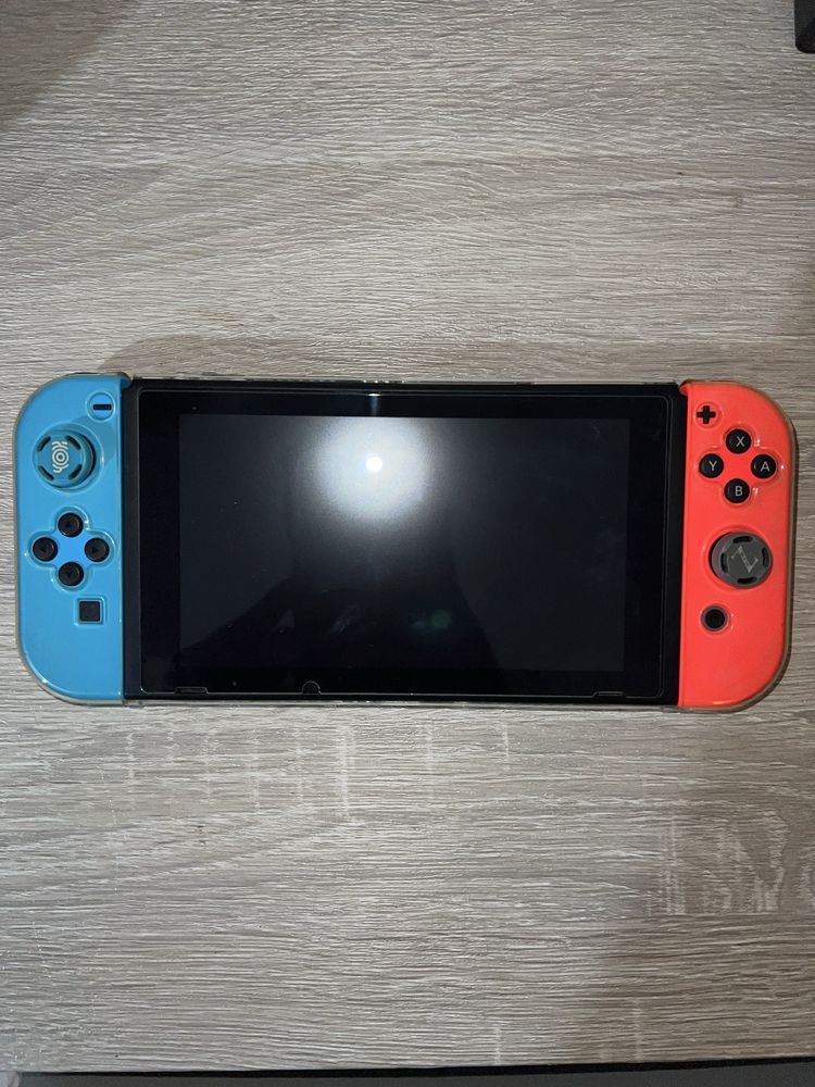 Nintendo Switch V2 com accesórios e um jogo
