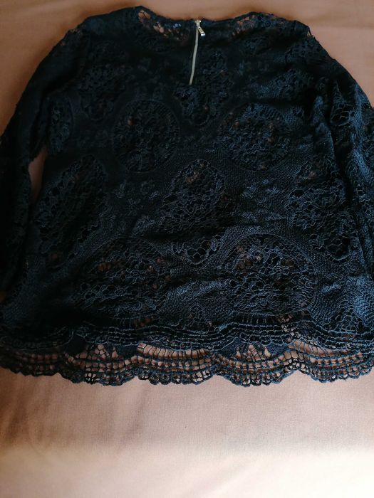 Blusa preta em renda de malha.