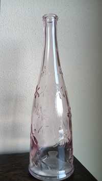 Szklany wazon w kształcie butelki w kwiaty różowy