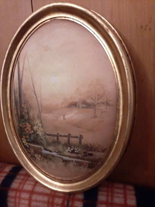 Quadro Vintage Oval em moldura dourada.