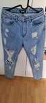 Niebieskie spodnie jeansowe z dziurami Missguided  r.36