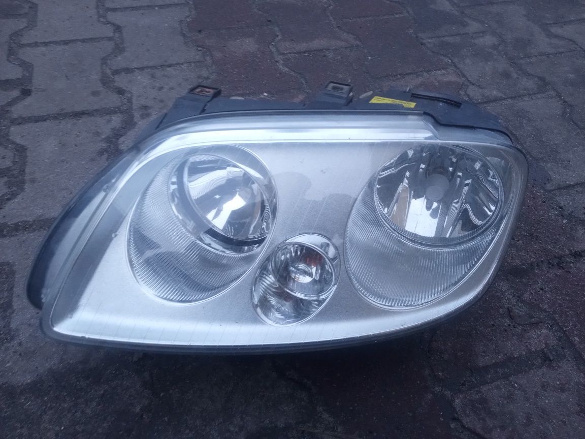 Reflektor lampa przednia lewa przód lewy VW caddy Turan