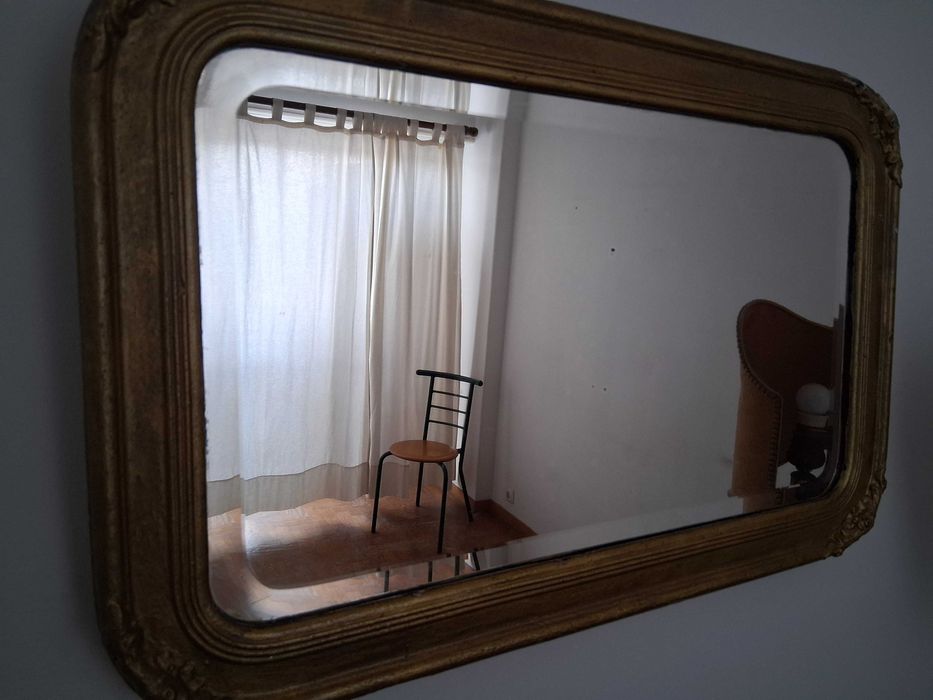 Espelho antigo com moldura dourada