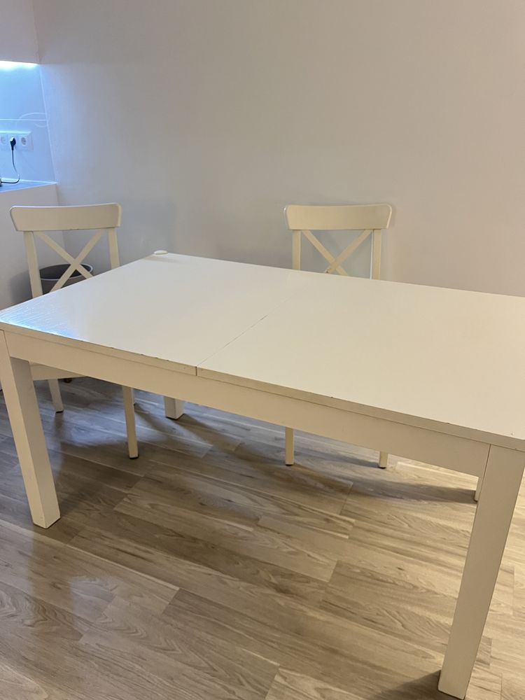 mesa extensivel com 2 cadeiras brancas