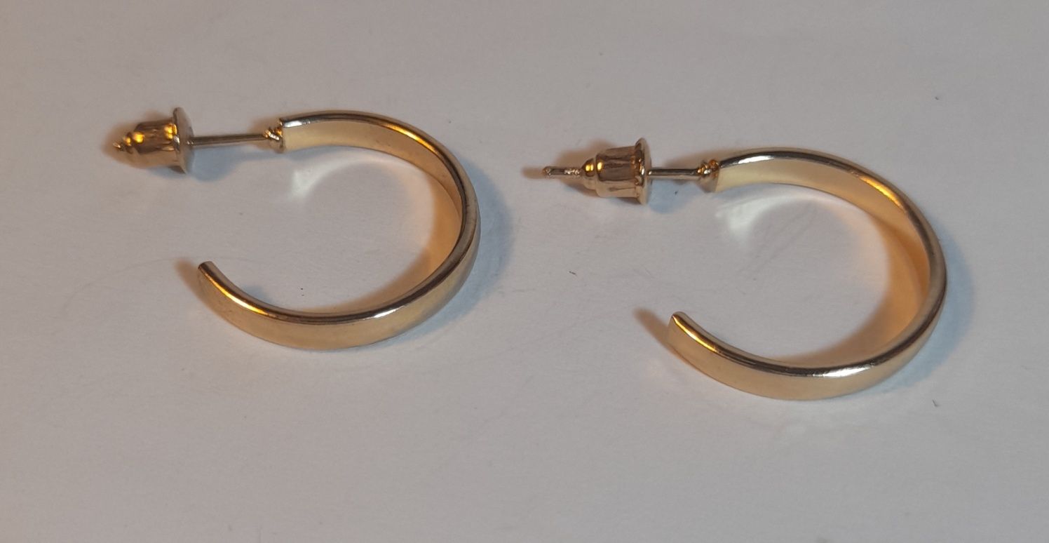 Gold hoop with spike.