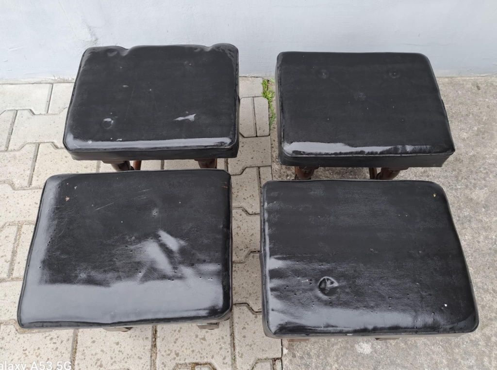 Czarne taborety z drewnianymi nóżkami