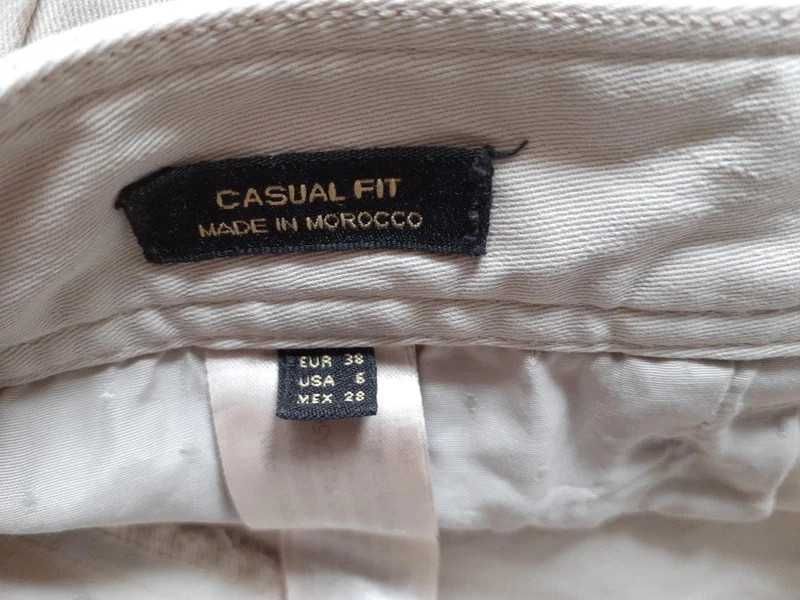 Beżowe spodnie dżinsowe o prostym kroju. Massimo Dutti