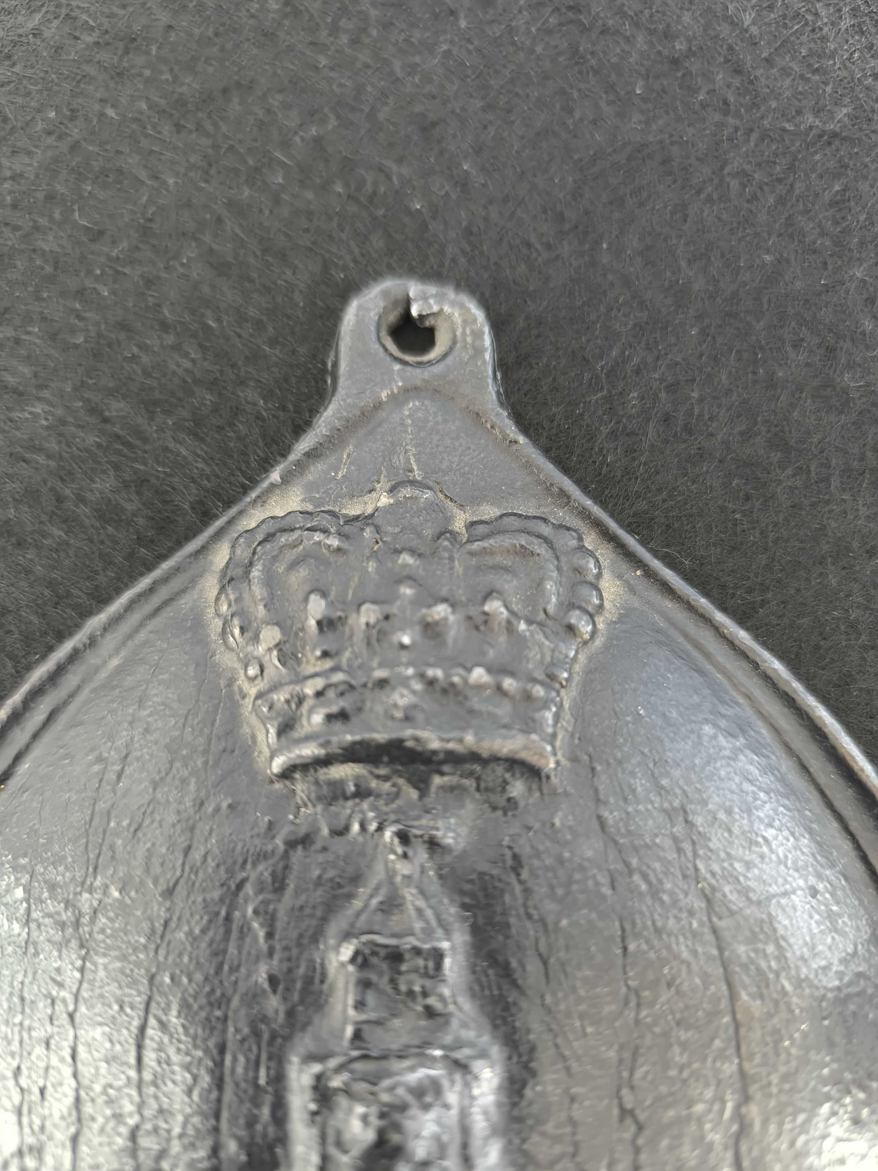Placa de metal com o n.º 754398, marcada com o emblema da seguradora