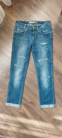 Spodnie damskie jeans 7/8 z rozdarciami C&A