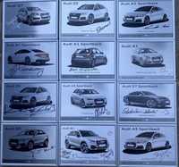 Autografy na tabliczkach z modelami Audi.