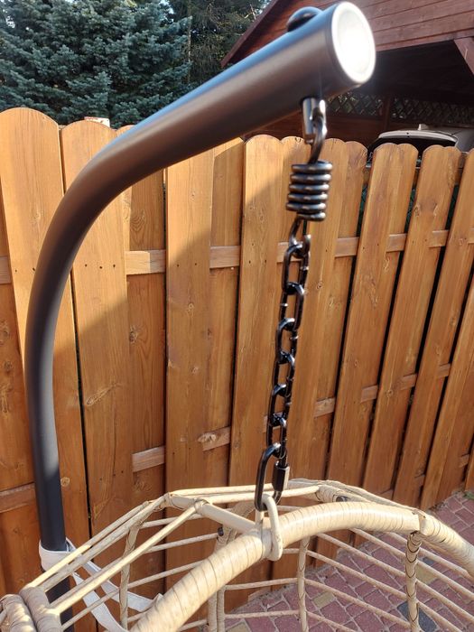 Fotel wiszący na stalowej podstawie z poduszką.