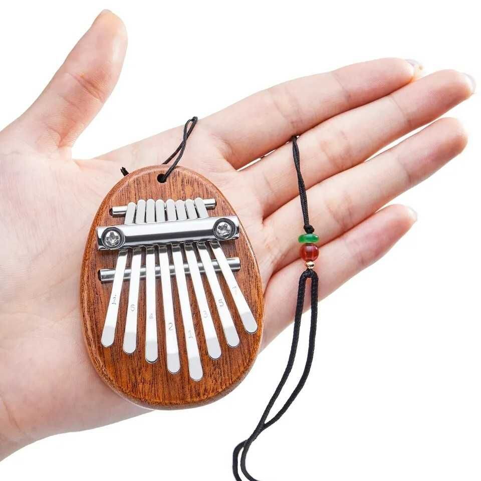 Mini Kalimba instrument afrykański w kształcie owalnym ze smyczą 8 nut