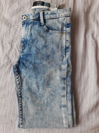 Damskie spodnie jeansowe jeansy Cropp
