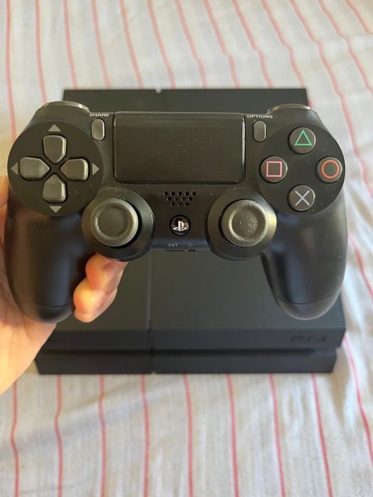 PlayStation 4 com comando e jogos