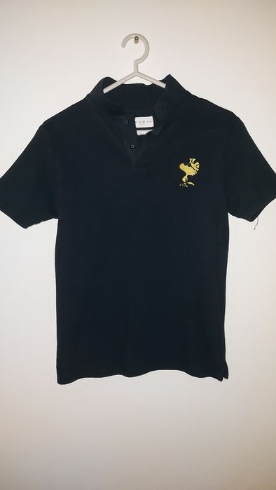Pólo preto Peanuts 9-10 anos
Novo