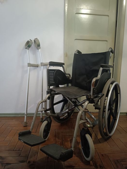 Cama articulada hospitalar com colchão, cadeira de rodas e muletas