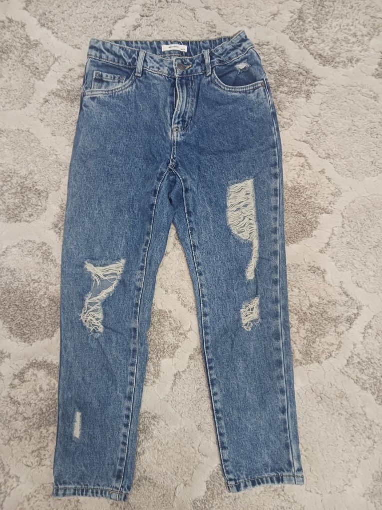 Spodnie jeans dziewczęce z dziurami roz 146 Reserved