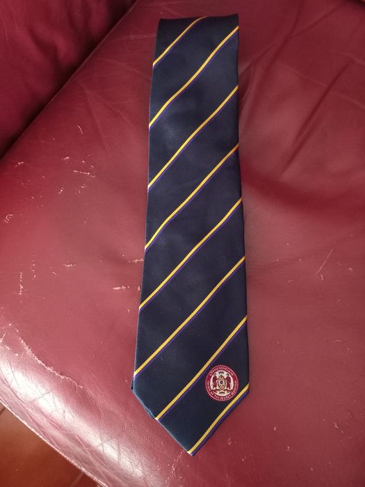 Gravatas novas em seda azul com emblema e riscas dourada e roxo