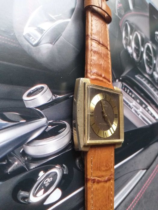 relogio newmark corda manual