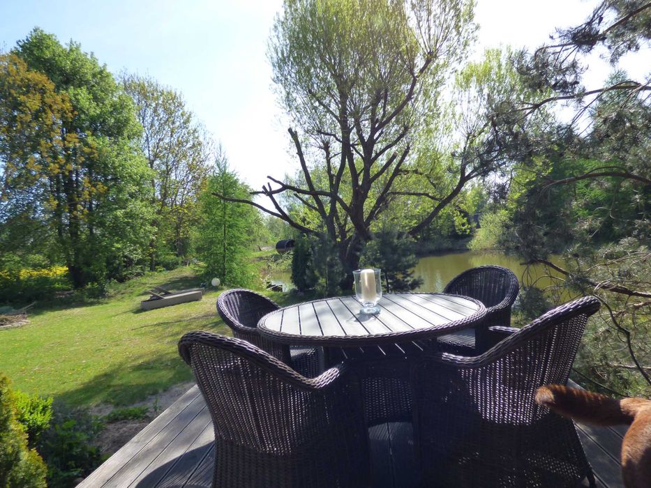 Urokliwy dom w otoczeniu zieleni z własnym stawem.