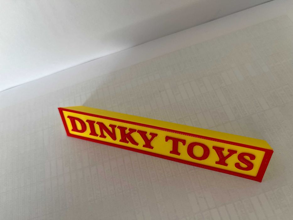 Sinal DINKY TOYS p/expositor miniaturas, paral. triang.reg., amarelo