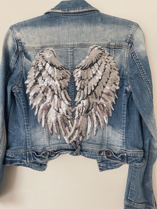 Blusão de ganga com asas prateadas aplicadas