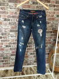 Spodnie jeansy bawełniane z dziurami GinaTricot rozm.XS