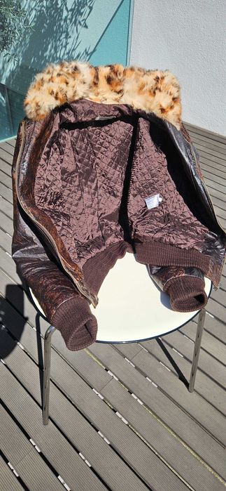 casaco de pele castanho com capucho.